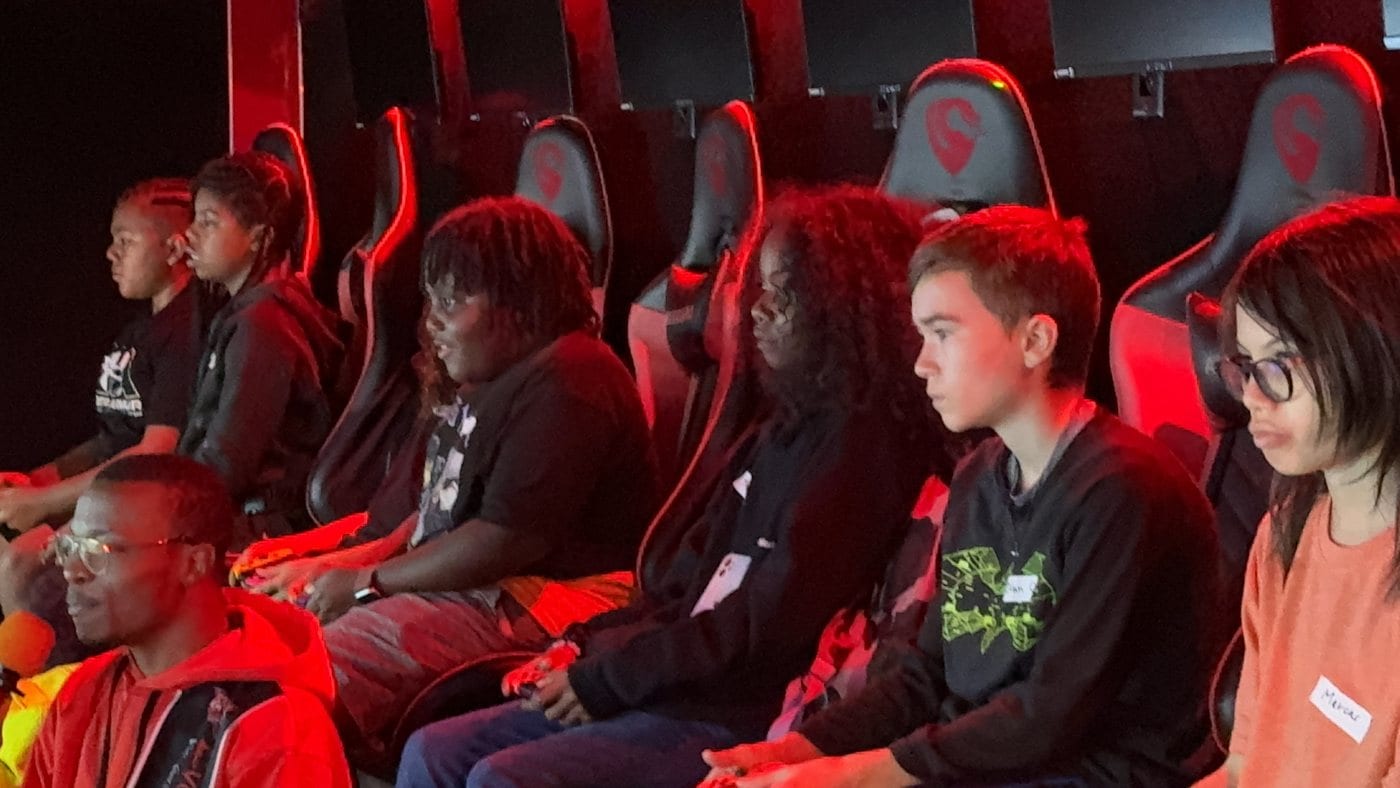 A crew of young gamers mid-party inside a Next Level Gaming theater in the DMV