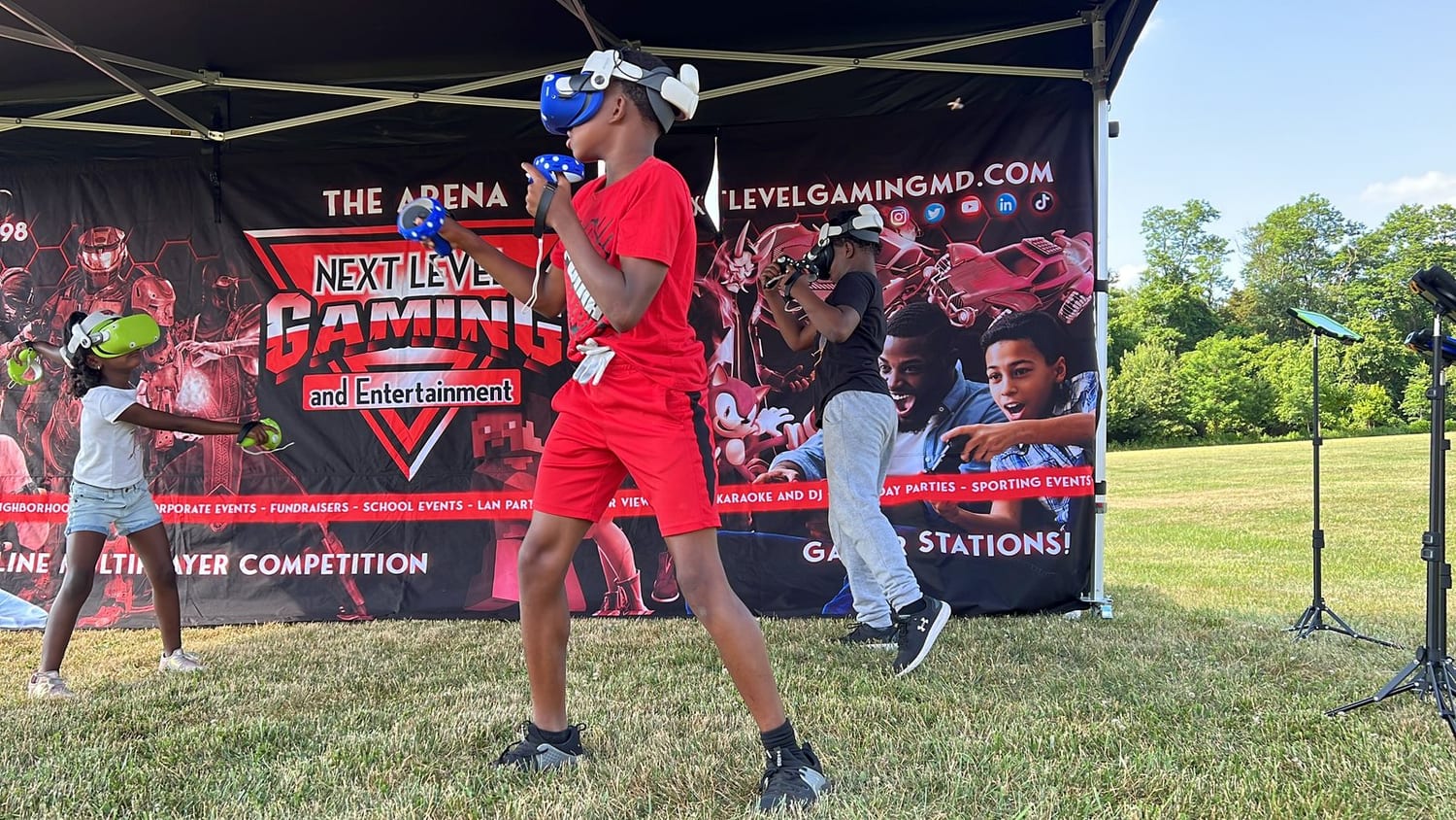 A player in a Meta Quest headset at an outdoor Next Level Gaming VR event in the DMV