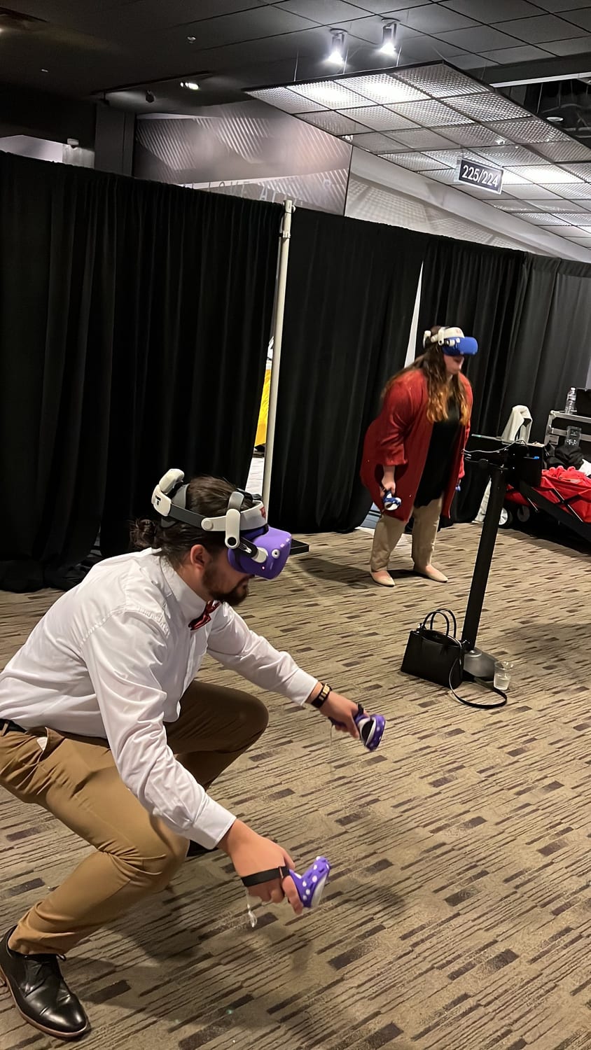 The Next Level Gaming team running a Meta Quest VR station at a DMV event